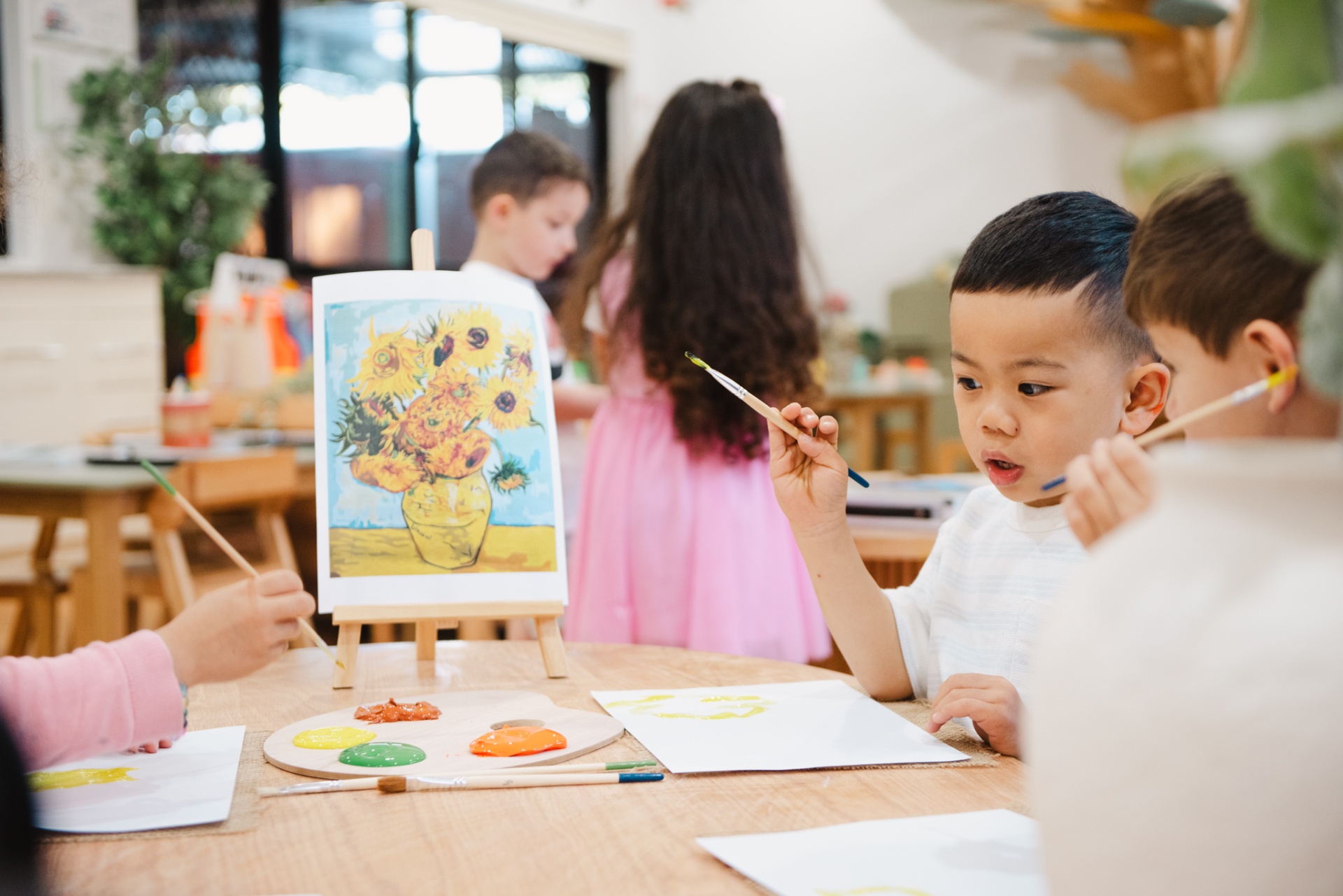 Children painting sunflowers
