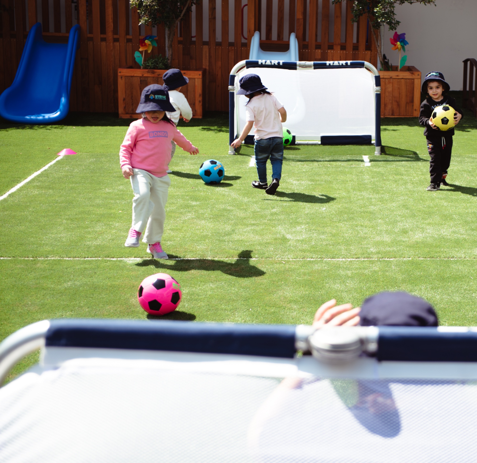 Children playing soccer in the outdoor yard