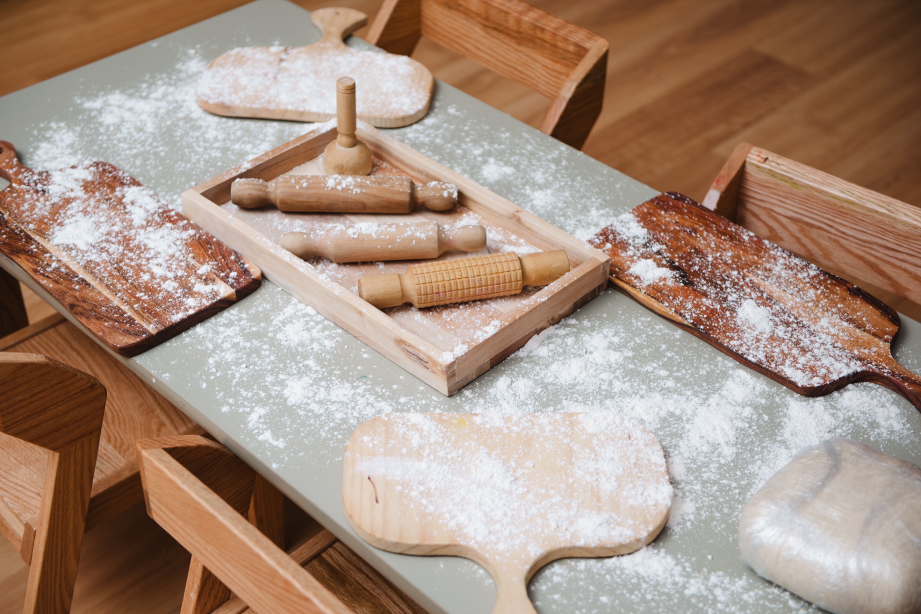 Wooden baking tools and flour on a table